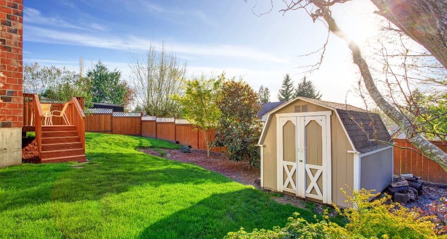 Fenced backyard with storage shed in Jefferson City